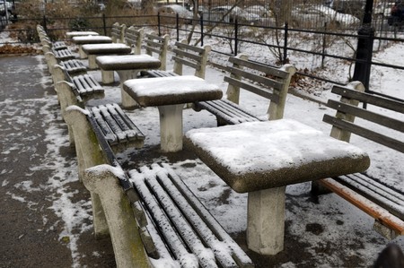 Chess tables outside in the park covered with snowの写真素材