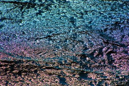 Solar patches of light are reflected in ocean water before a sunsetの写真素材