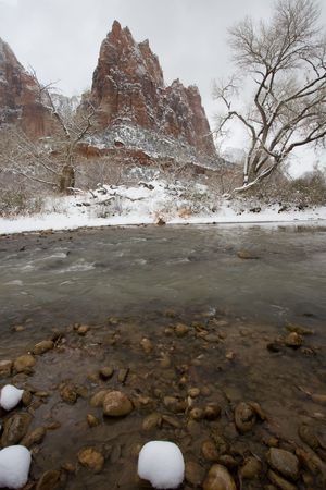 View of jagged mountain and river during snow storm inside Zion National Park, Utah, USA.の写真素材