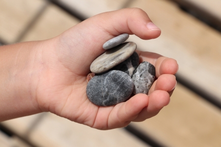 Set of pebble in the child handの写真素材