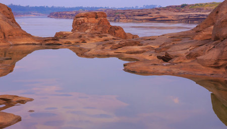 Rock beneath the river . In Pho Sai Province Caused by water erosion . A pool of more than 3,000 wells.の写真素材