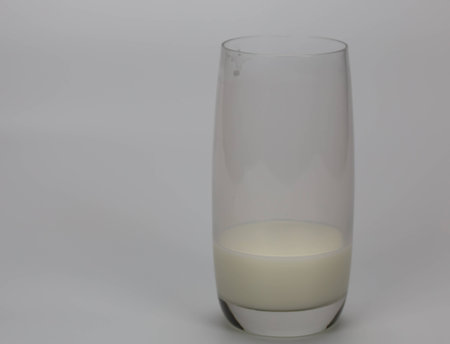 Milk is a pale liquid produced by the mammary glands of mammals.I focus on the glass edgeの写真素材