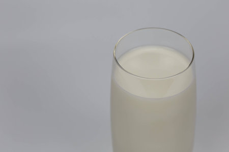 Milk is a pale liquid produced by the mammary glands of mammals.I focus on the glass edgeの写真素材