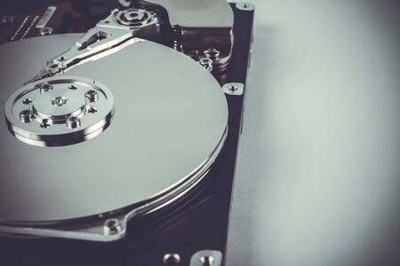 Disassembled hard drive on a white background with place for your text, soft focus, tonedの写真素材