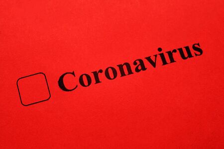 Coronavirus - checkbox with a tick on red paper. Checklist concept.の写真素材