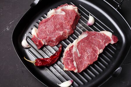 two steaks in a pan for grilling, macroの写真素材