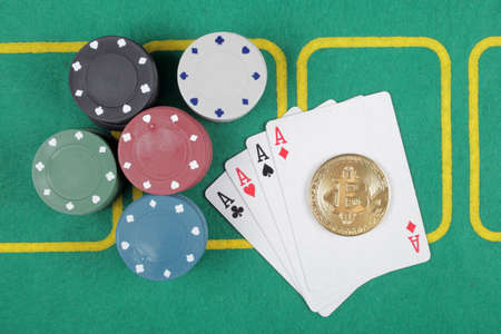 Casino chips winning combination four aces, golden bitcoin, top view.