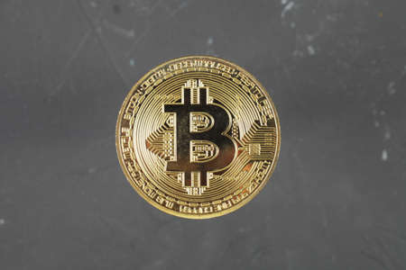 Gold bitcoin on a dark background, selective focus, copy space.の写真素材