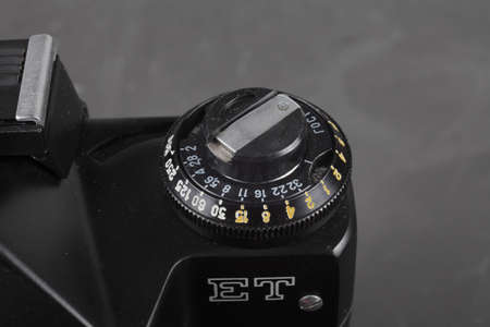 old SLR camera on a concrete background, film rewind lever.