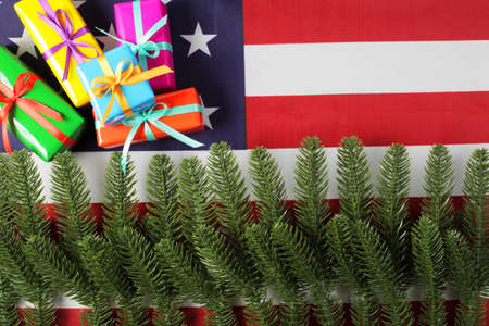 artificial fir branches and gift boxes on american flag, top viewの写真素材