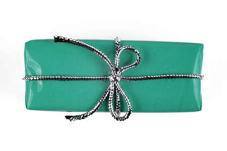 turquoise christmas gift with silver bow isolated on white background, top view, closeupの写真素材