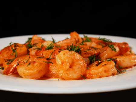 Fried king prawns on a white plate, close-upの写真素材