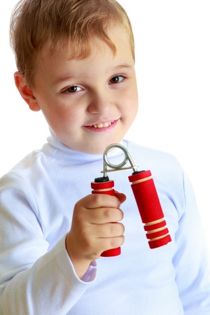 Athletic development, fitness and sports for children concept.Little boy with dumbbells in his hands.の写真素材