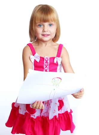 Happy childhood, joy of learning, creativity, child concept.little girl in a red dress draws.Isolated on white background.の写真素材