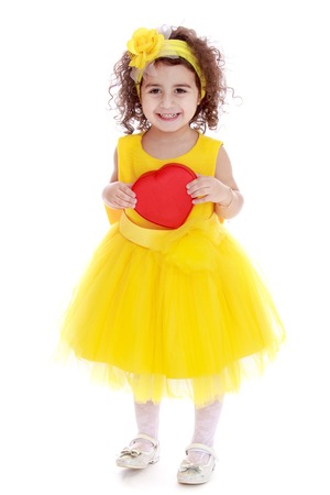 Girl in yellow dress self-pity heart.Isolated on white background.の写真素材