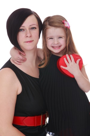 Happy childhood, the family concept.Close-up little girl hugging beloved mother.Isolated on white.の写真素材