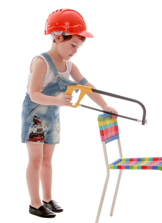 little boy in front of a chair hacksaw. Isolated on white.の写真素材