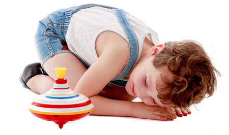 Little boy bent down to look like a spinning pinwheel. Isolated on white.