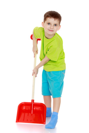 Funny boy with a shovel in his hands. - isolated on white backgroundの写真素材