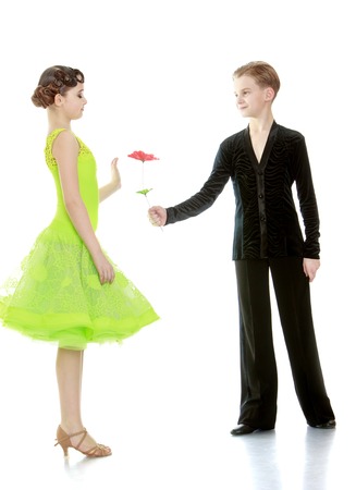 The young man gives a flower to a charming young girl-isolated on white backgroundの写真素材