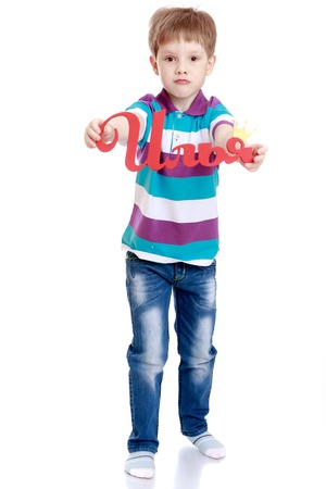 Beautiful Russian boy in jeans and a striped t-shirt holding a sign with his name-Isolated on white backgroundの写真素材