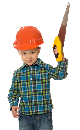 Llittle boy in a hard hat holding a saw - Isolated on white backgroundの写真素材