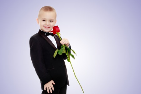 Little boy with a rose flower.の写真素材
