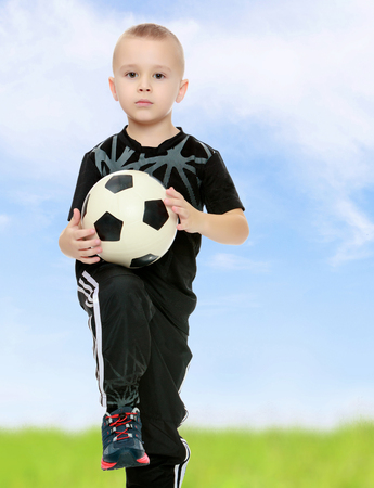 The little boy with the ball in his handsの写真素材