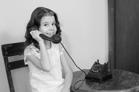 The girls ringing on the old phone.の写真素材