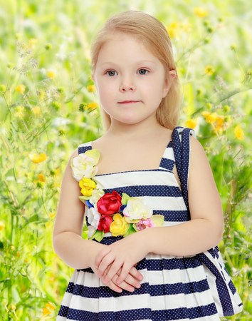 Little girl in a striped dress.の写真素材