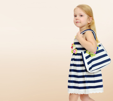 Little girl in a striped dress.の写真素材