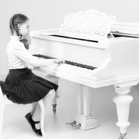 A girl from a music school plays the piano.の写真素材
