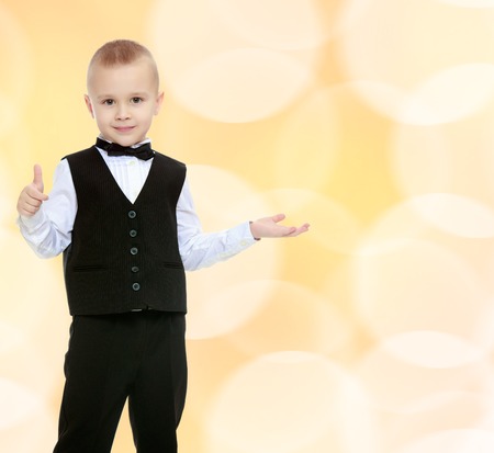 Trendy little boy in a black suit with a tie.の写真素材