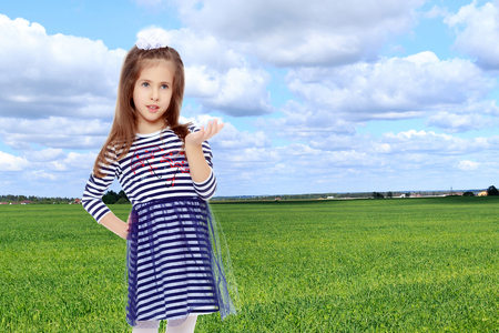 Cute little girl posing in front of the camera.の写真素材
