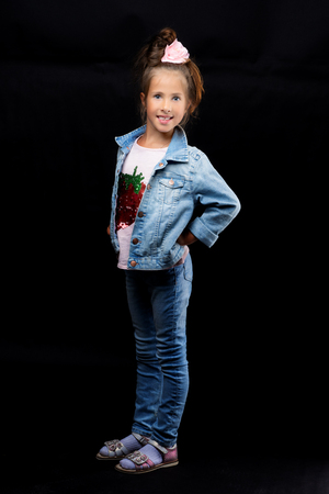 Little girl on a black backgroundの写真素材