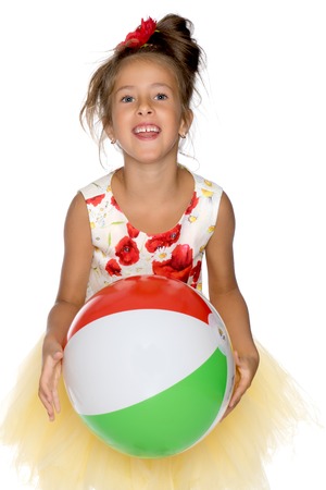 Little girl is playing with a ballの写真素材