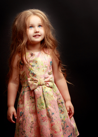 Little girl on a black backgroundの写真素材