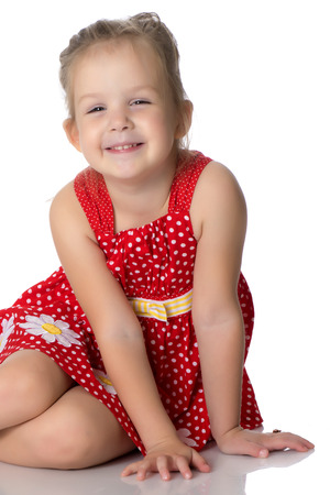 Little girl is sitting on the floor.の写真素材