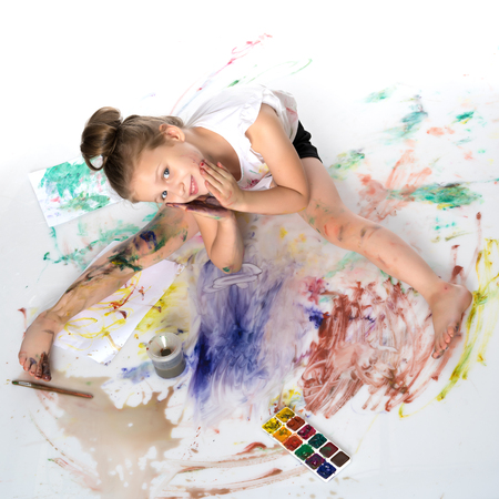 The little girl got dirty with the paints.の写真素材