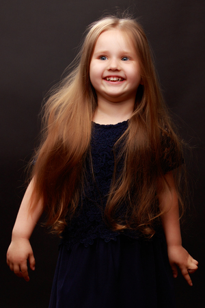 Little girl on a black backgroundの写真素材