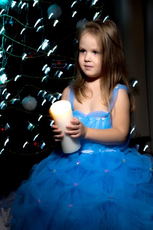 A little girl is holding a candle.の写真素材
