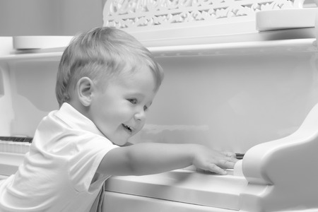 Little boy playing the pianoの写真素材