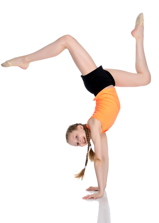 The gymnast performs a handstand with bent legs.の写真素材