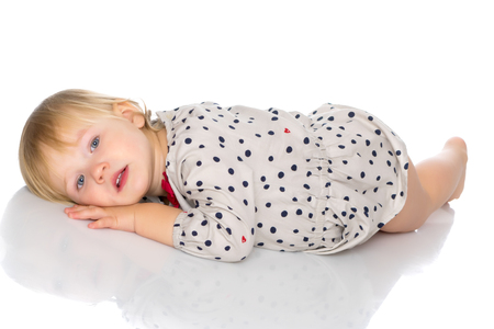 Little girl lies on the floorの写真素材