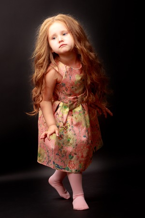 Little girl on a black backgroundの写真素材