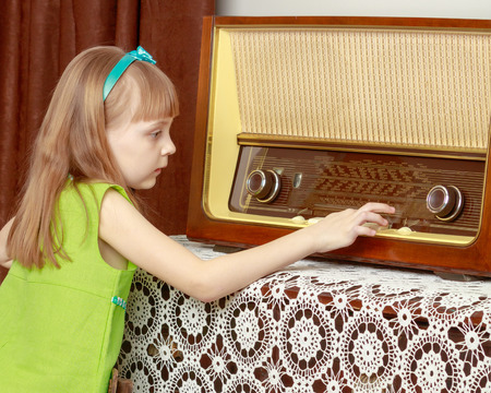 A little girl with long blond hair and a short bangs, in a shortの写真素材