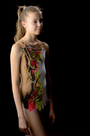 Girl gymnast on a black backgroundの写真素材