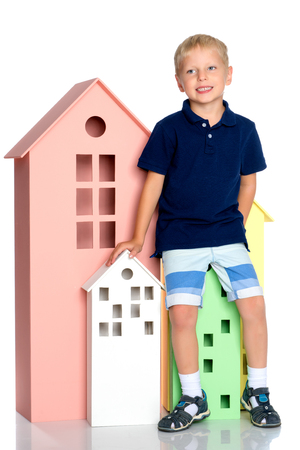 A little boy is playing with colorful houses.の写真素材