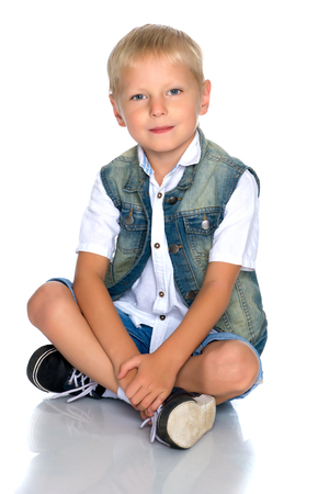 little boy is sitting on the floorの写真素材