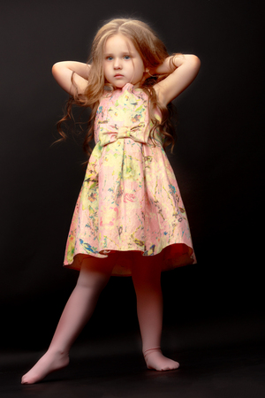 Little girl on a black backgroundの写真素材